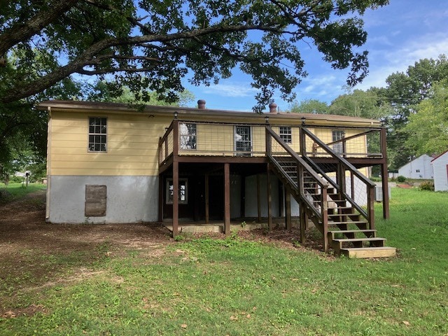 back of house with a lawn and a wooden deck