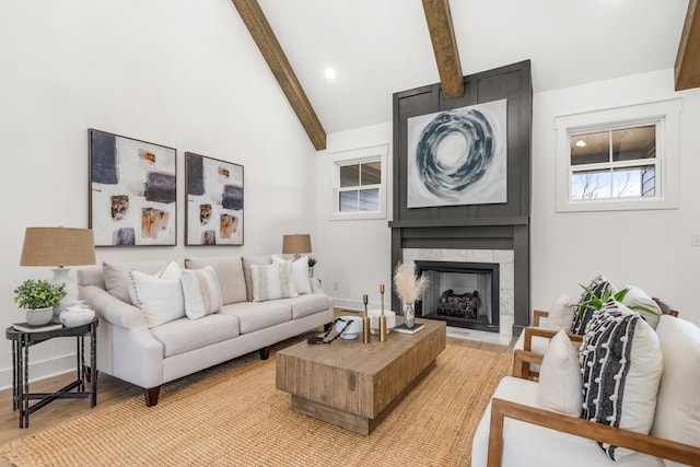 living room featuring vaulted ceiling with beams, a fireplace, and wood-type flooring