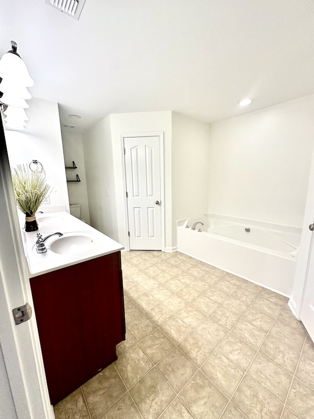 bathroom featuring vanity, tile patterned floors, and a bathtub