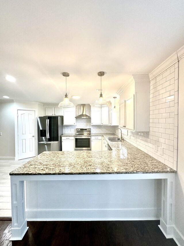 kitchen featuring white cabinets, appliances with stainless steel finishes, dark hardwood / wood-style floors, wall chimney exhaust hood, and decorative light fixtures