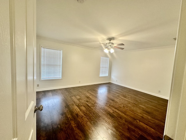 spare room with crown molding, dark hardwood / wood-style flooring, and ceiling fan