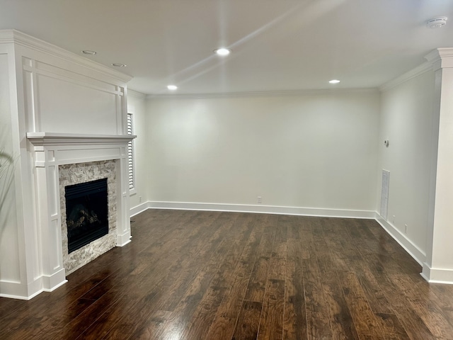 unfurnished living room with ornamental molding, a fireplace, and dark hardwood / wood-style floors