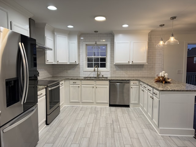 kitchen featuring white cabinetry, appliances with stainless steel finishes, sink, and pendant lighting