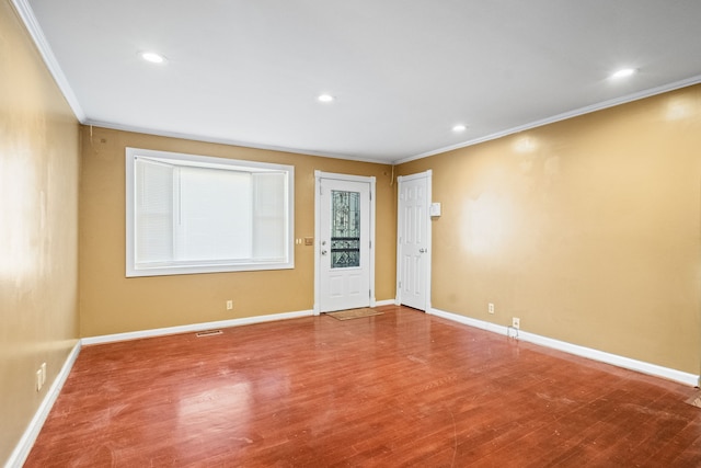 unfurnished room featuring crown molding and hardwood / wood-style floors