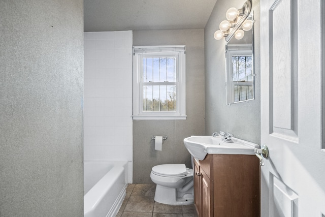 bathroom featuring tile patterned floors, plenty of natural light, vanity, and toilet