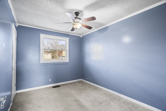 carpeted empty room with a textured ceiling, ceiling fan, and ornamental molding