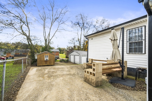 view of patio / terrace with a garage and a storage unit