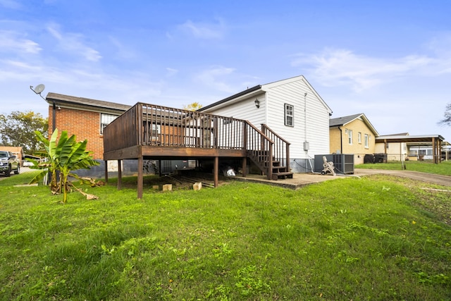 rear view of house with a lawn, central air condition unit, and a wooden deck