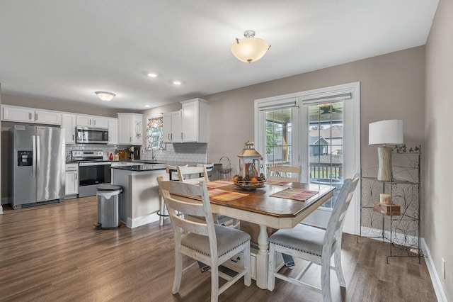 dining space featuring sink and dark hardwood / wood-style floors