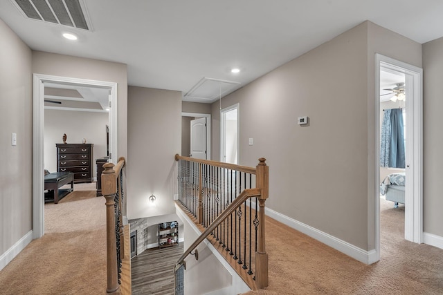 corridor featuring light colored carpet