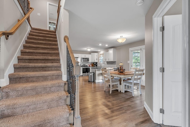 stairs with wood-type flooring