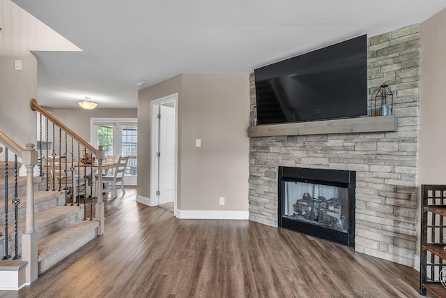 living room with a fireplace and dark hardwood / wood-style flooring