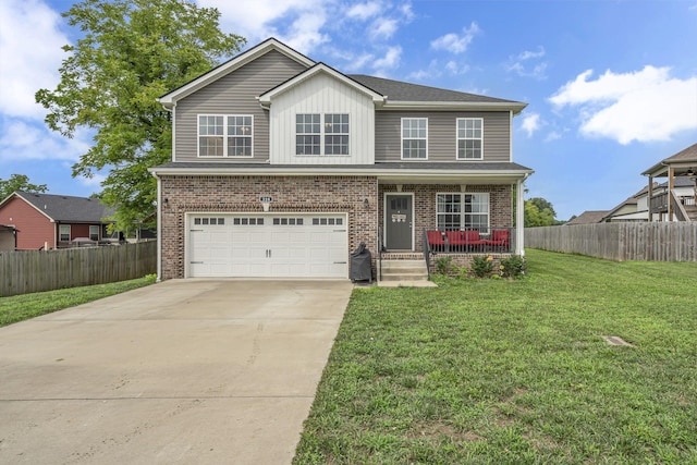 view of front of home featuring a porch, a garage, and a front lawn