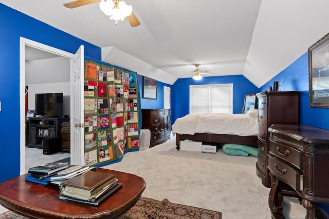 carpeted bedroom featuring ceiling fan and vaulted ceiling