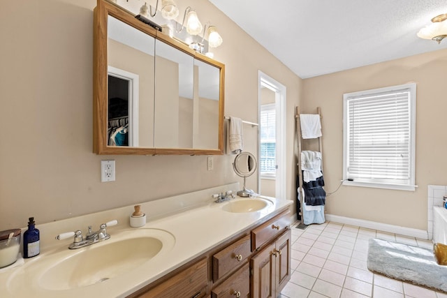 bathroom featuring tile patterned flooring, vanity, and a bathing tub