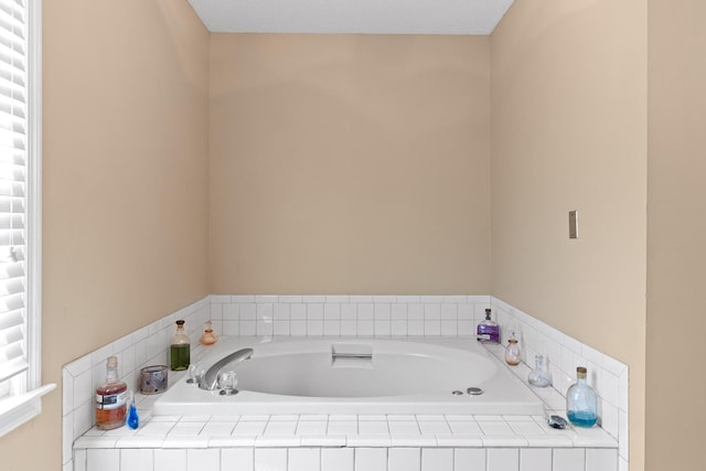 bathroom featuring tiled tub