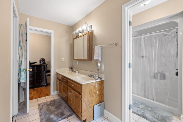 bathroom featuring walk in shower, tile patterned floors, and vanity