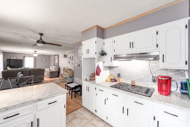 kitchen featuring black electric cooktop, light hardwood / wood-style flooring, ceiling fan, decorative backsplash, and ornamental molding