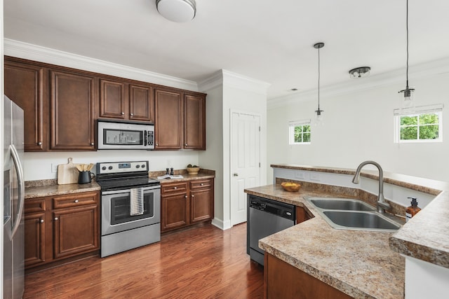 kitchen featuring stainless steel appliances, sink, decorative light fixtures, dark hardwood / wood-style flooring, and ornamental molding