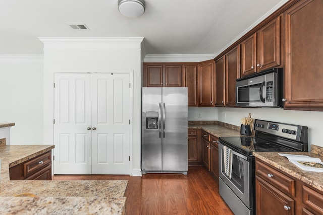 kitchen featuring crown molding, appliances with stainless steel finishes, and dark hardwood / wood-style flooring