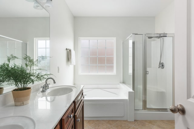 bathroom featuring tile patterned floors, separate shower and tub, and double sink vanity