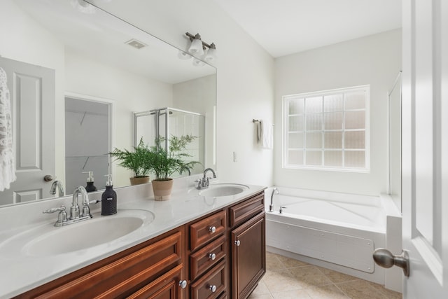 bathroom featuring plus walk in shower, tile patterned floors, and dual bowl vanity