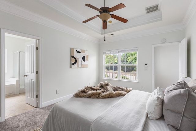 bedroom with ceiling fan, ensuite bath, crown molding, a raised ceiling, and light tile patterned floors