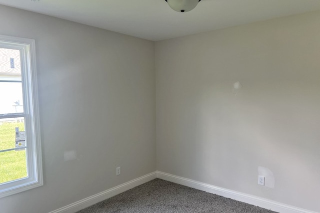 spare room with carpet and baseboards