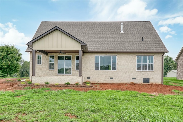 back of house featuring a lawn and ceiling fan