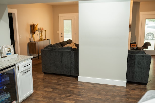 living room featuring dark hardwood / wood-style floors and beverage cooler