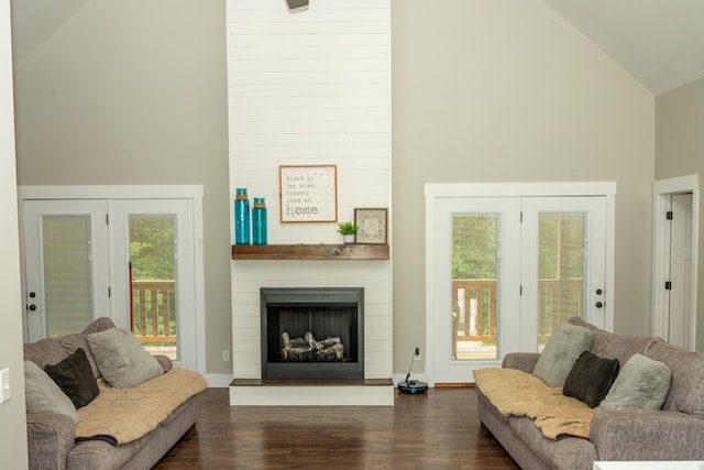 living room with dark hardwood / wood-style flooring, a fireplace, french doors, and high vaulted ceiling