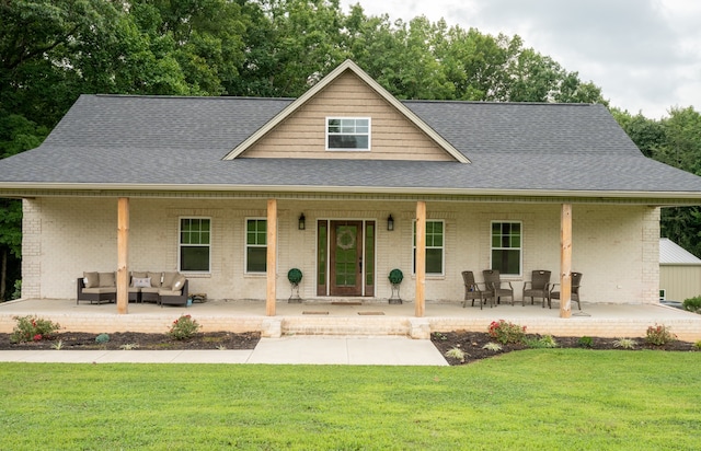 view of front facade with an outdoor living space, an outdoor structure, and a front yard