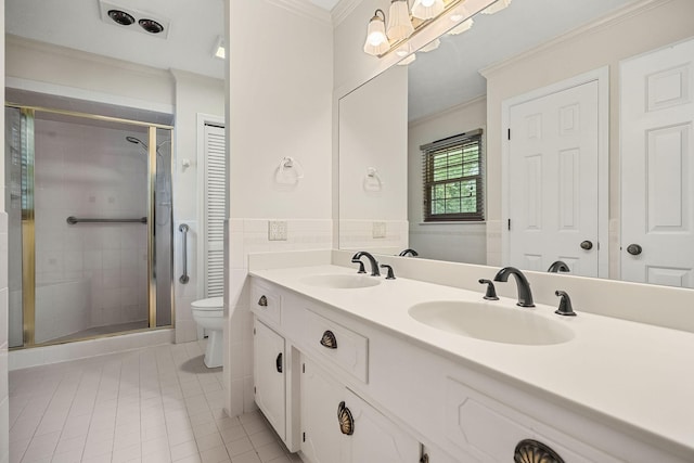 bathroom with tile patterned flooring, vanity, an enclosed shower, ornamental molding, and toilet