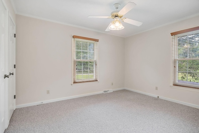 carpeted spare room featuring ornamental molding and ceiling fan