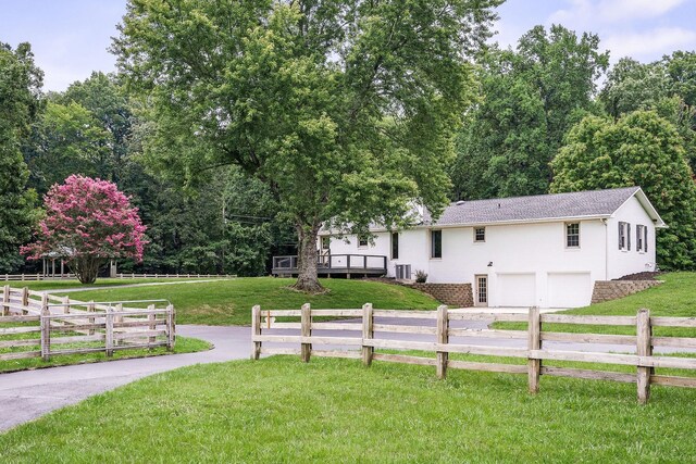 exterior space featuring a garage and a front lawn