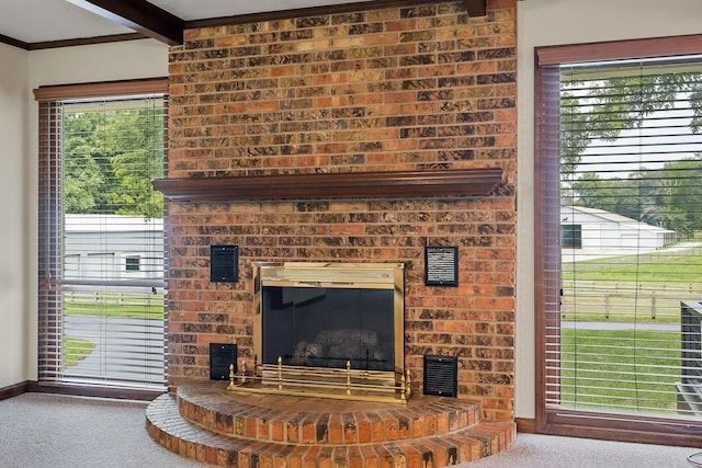 carpeted living room featuring a fireplace and beam ceiling