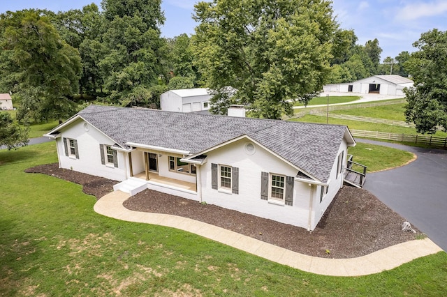 view of front of property with covered porch and a front lawn