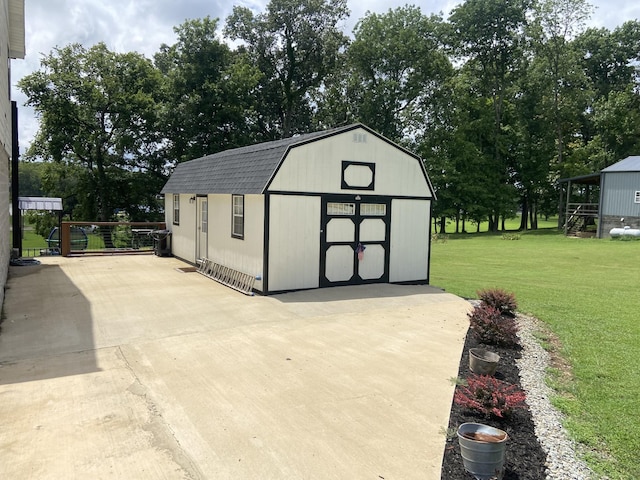 view of outbuilding with a yard