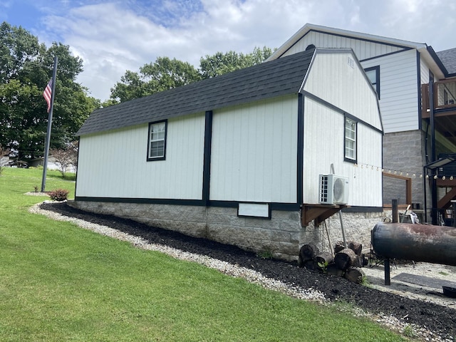 view of side of home featuring a yard and ac unit