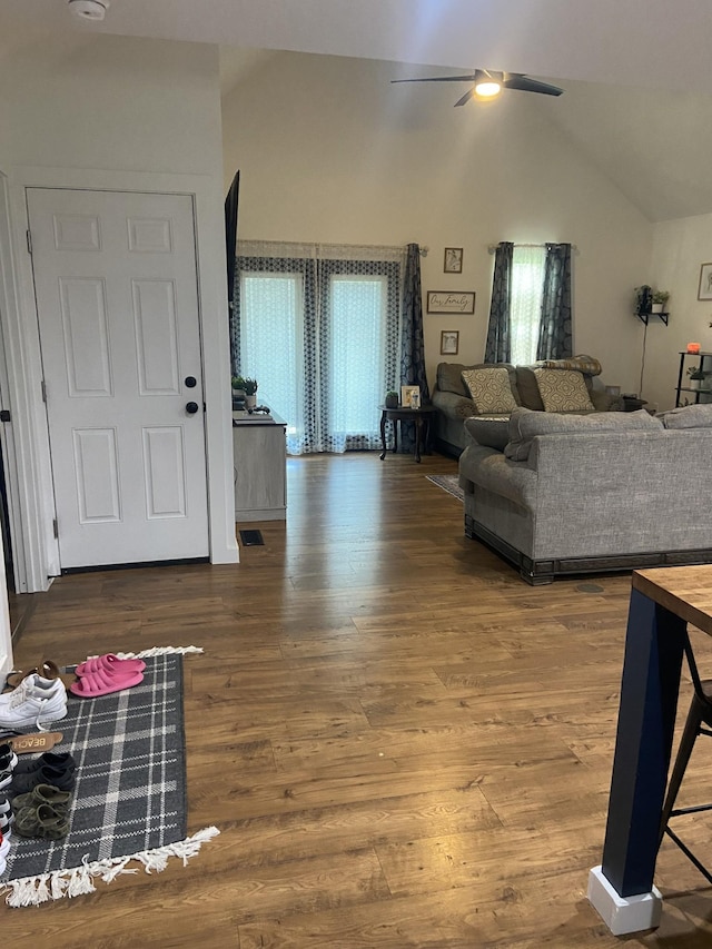 living room featuring lofted ceiling, hardwood / wood-style floors, and ceiling fan