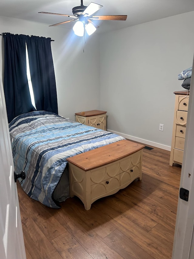 bedroom with dark wood-type flooring and ceiling fan