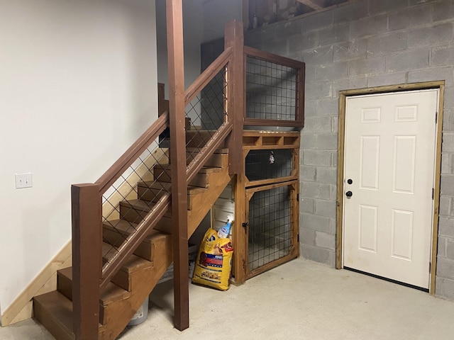 staircase featuring concrete flooring