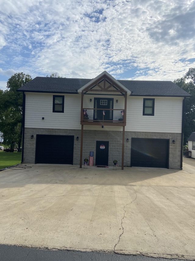 view of front facade with a garage and a balcony