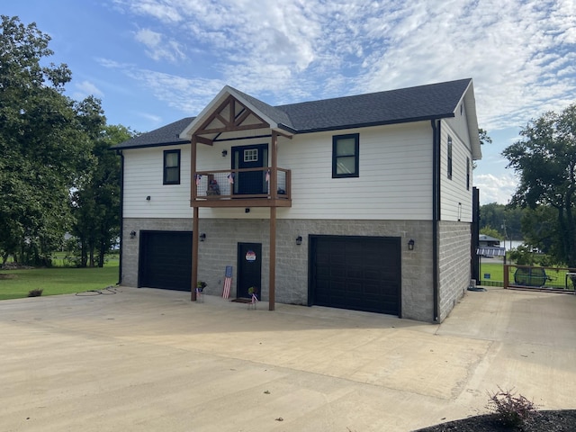 view of front of house featuring a garage and a balcony