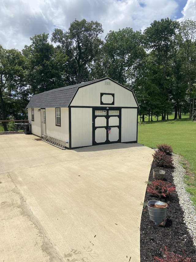 view of outbuilding with a lawn