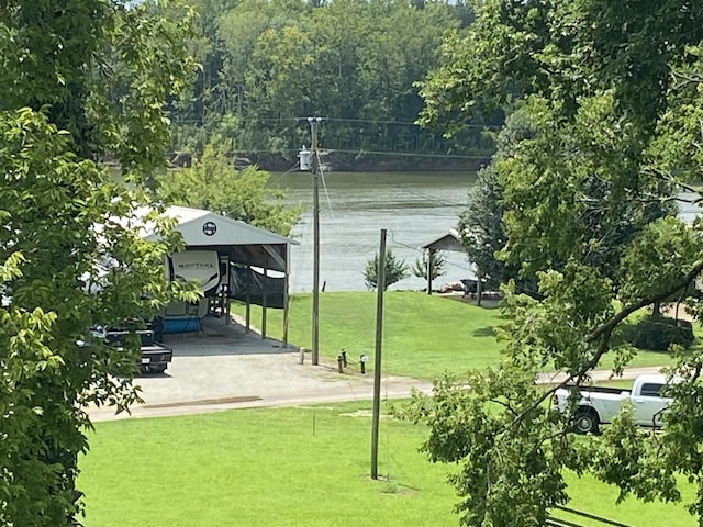 surrounding community featuring a water view and a lawn