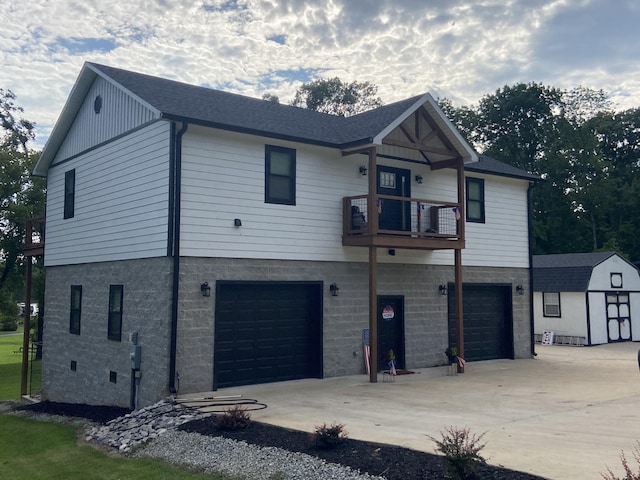 view of front of property with a garage and a balcony