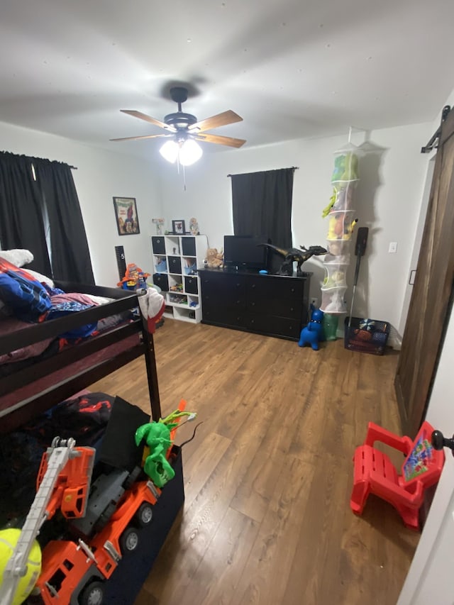 bedroom with hardwood / wood-style flooring and ceiling fan