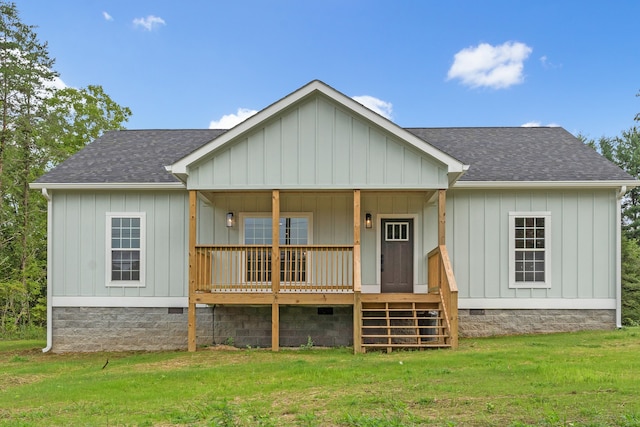 rear view of house with a porch and a lawn