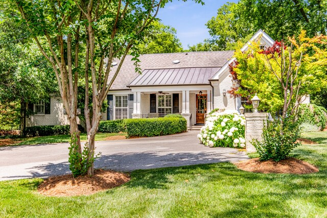 view of front of house with a porch and a front yard